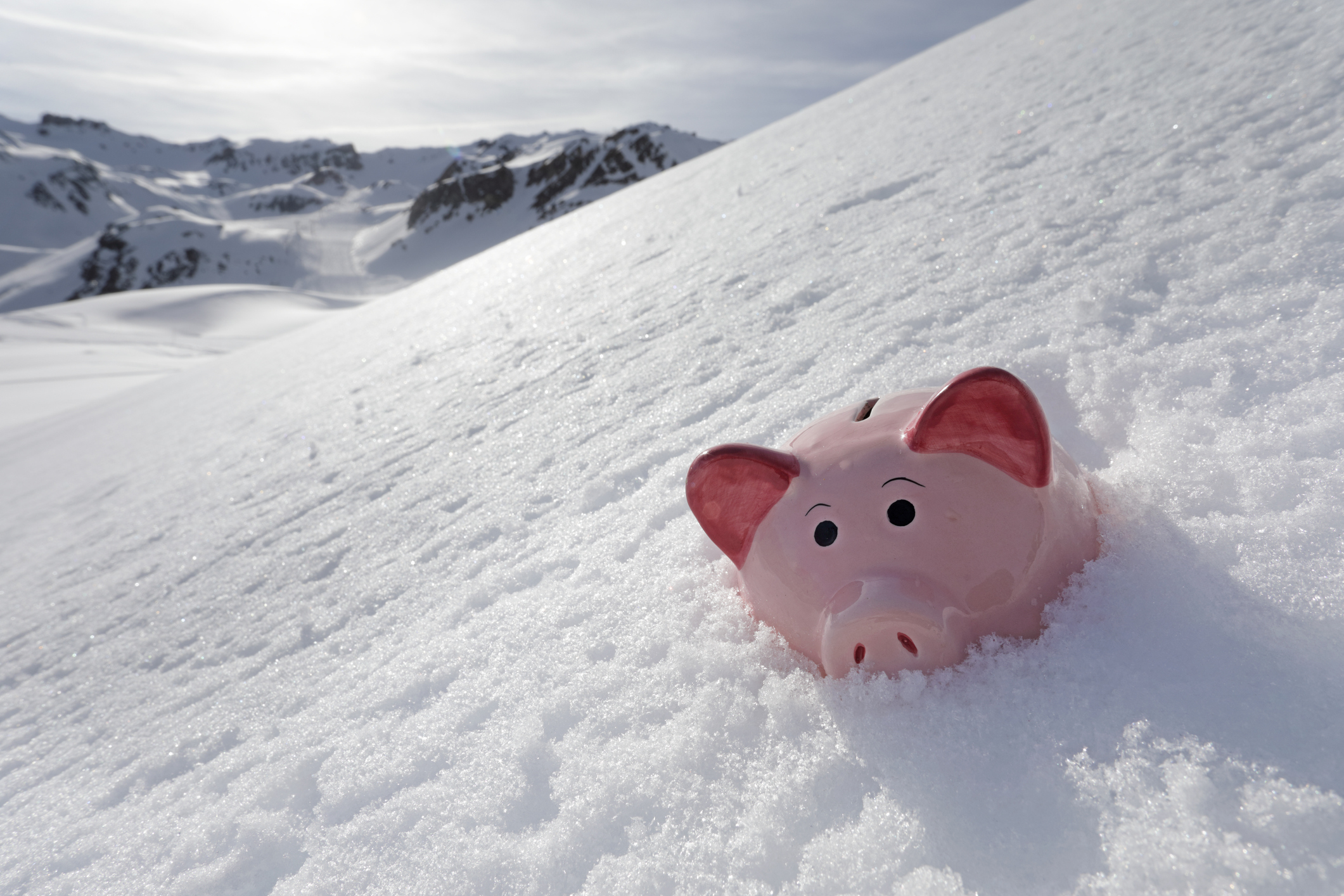 Piggy bank buried in snow