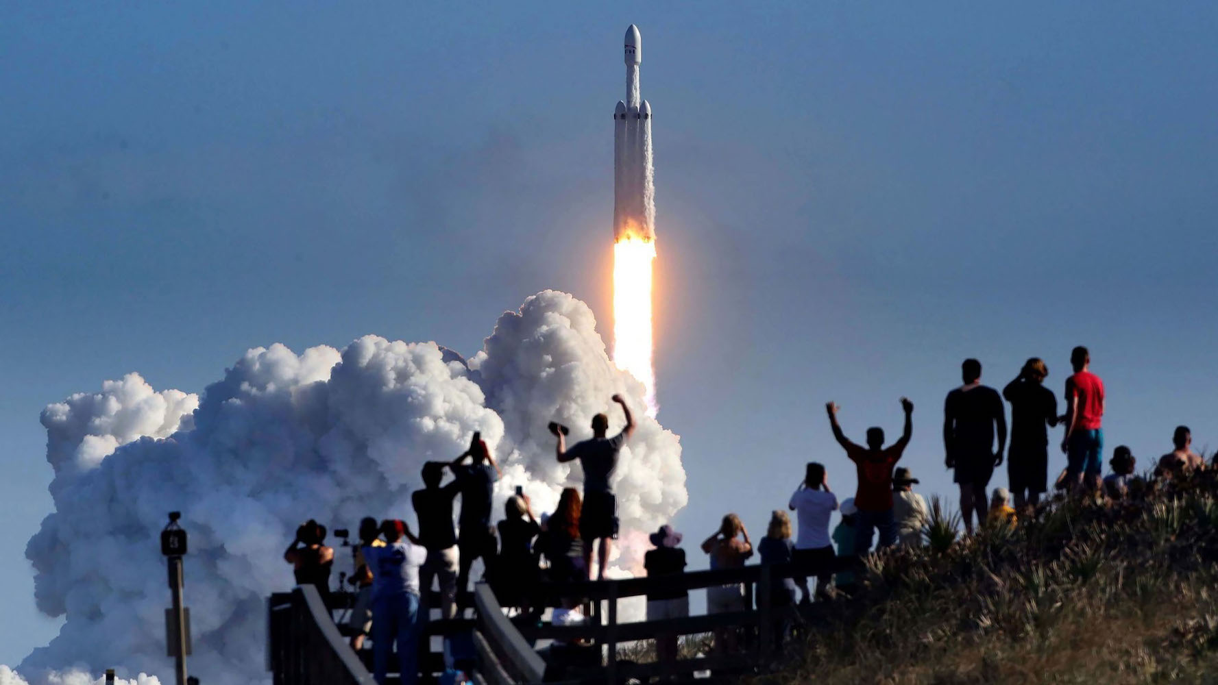 The crowd cheers on Playalinda Beach in the Canaveral National Seashore, just north of the Kennedy Space Center, during the launch of the SpaceX Falcon Heavy rocket on Feb. 6, 2018. Playalinda is one of the closest public viewing spots to see the launch, about 3 miles from the SpaceX launch pad 39-A.  (Joe Burbank/Orlando Sentinel/Tribune News Service via Getty Images)