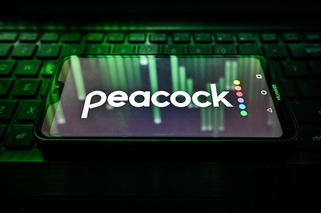 Peacock logo on the phone sitting on the keyboard