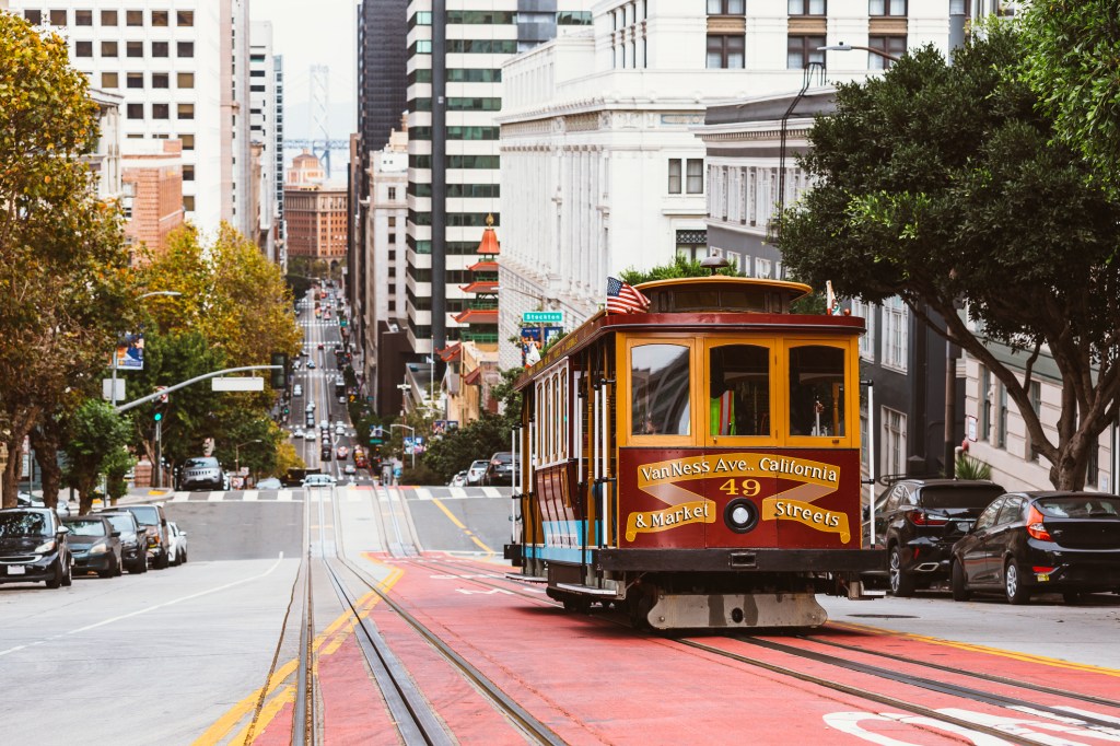 Street in San Francisco with historic cable car, California, USA