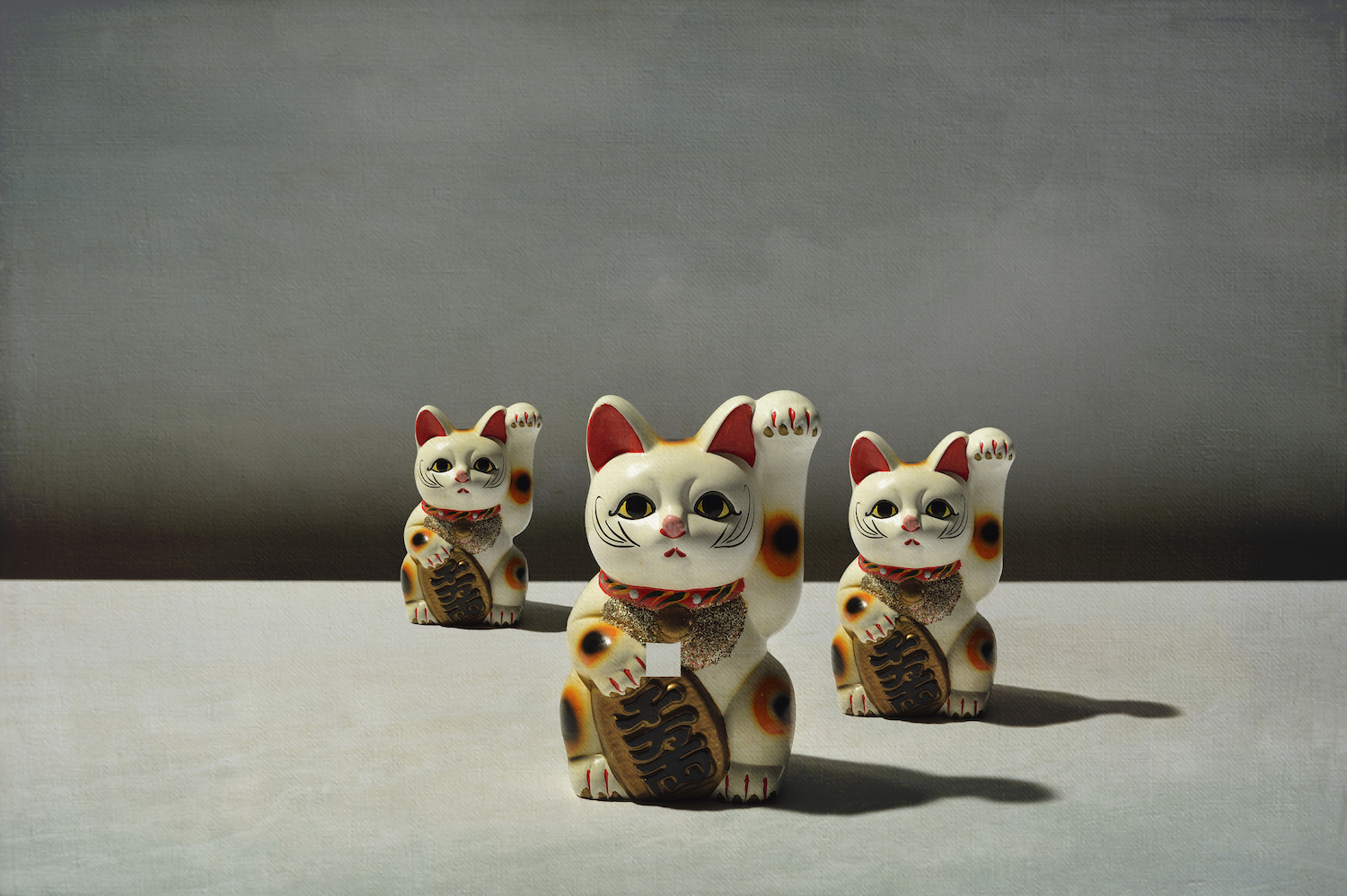 The maneki-neko (literally "beckoning cat") is a common Japanese figurine (lucky charm, talisman) which is often believed to bring good luck to the owner.
