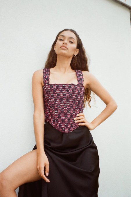 Curated Loop fashion rental startup model wearing a corset top and black skirt