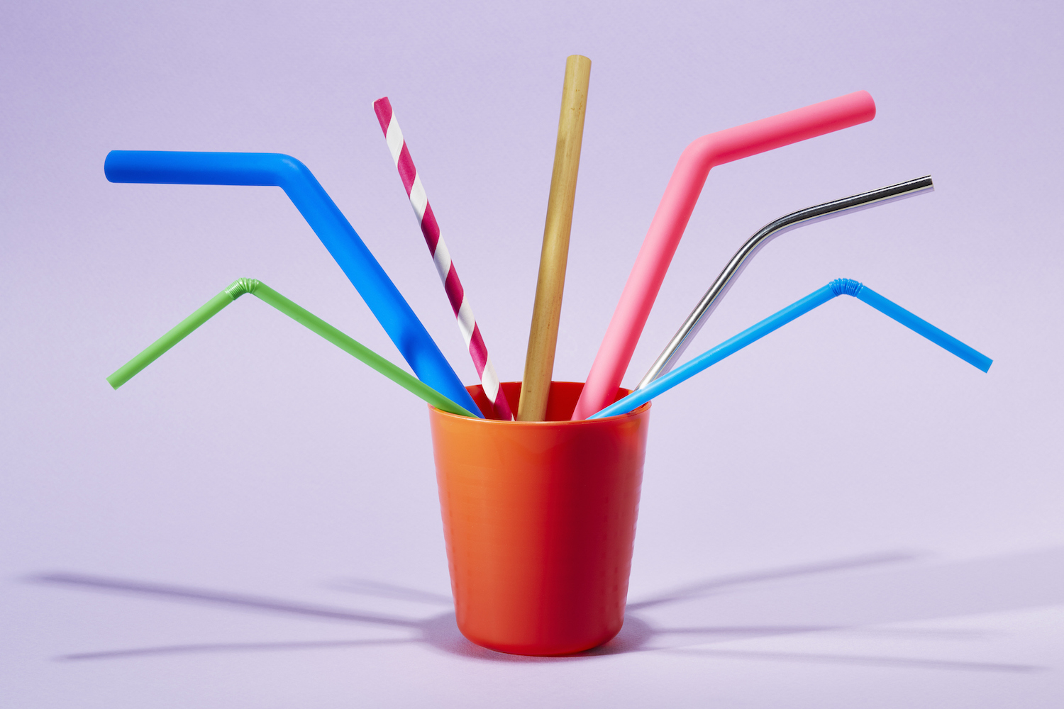Seven different drinking straws in a cup