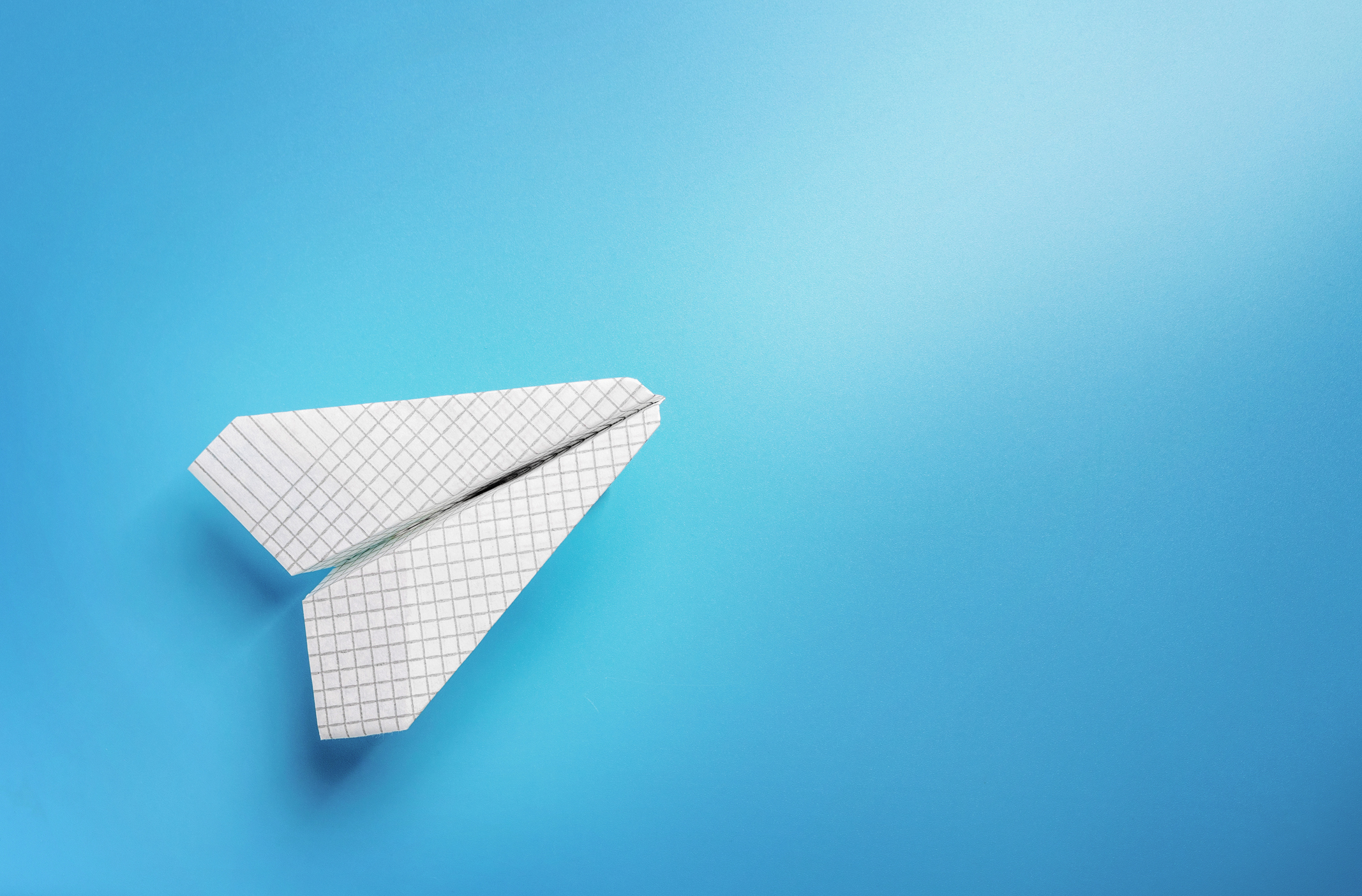 Paper plane on a blue background.