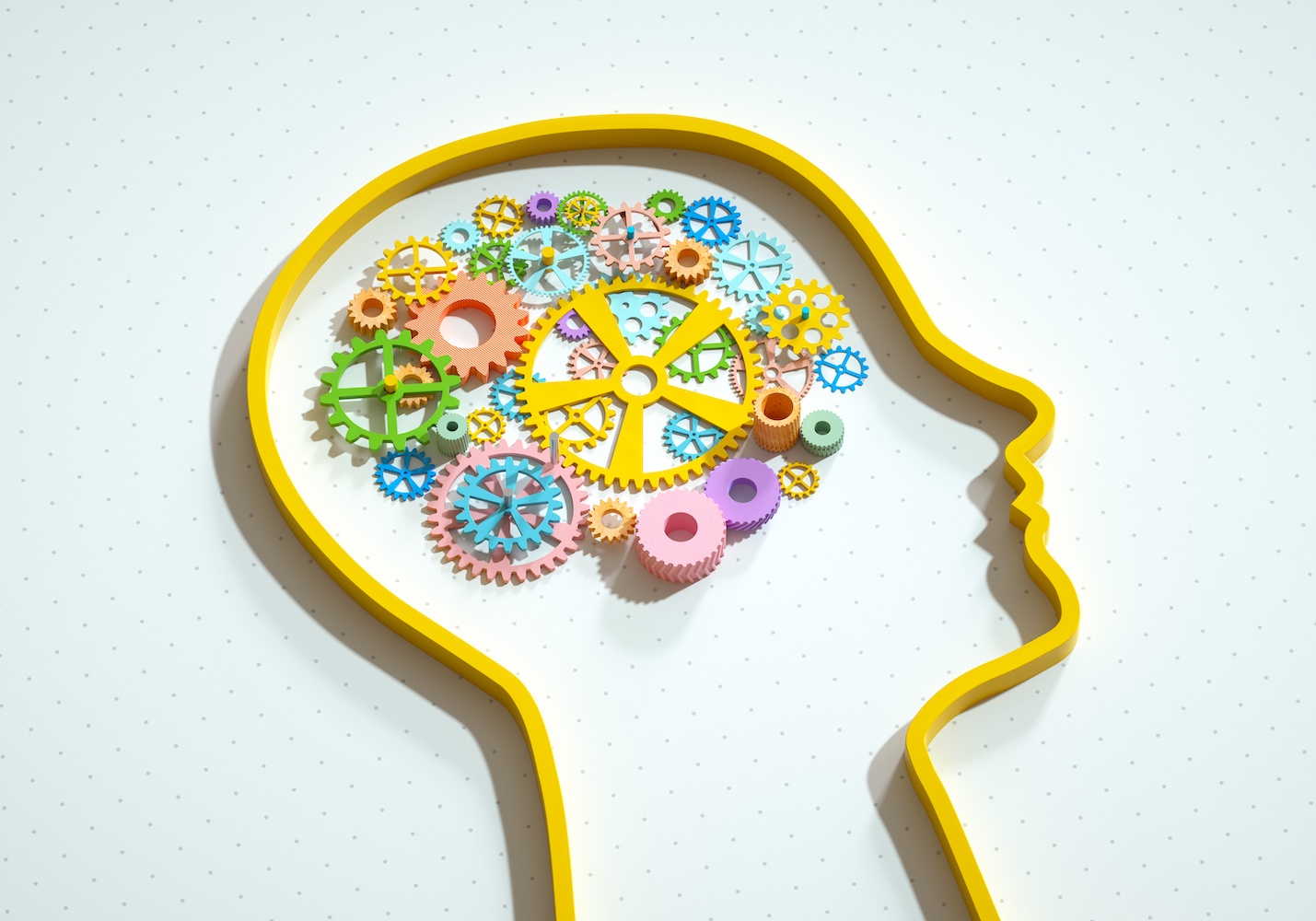 Digital generated image of silhouette of male head with multicoloured gears inside on white background.