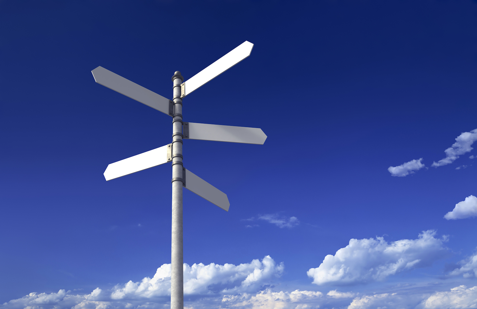 Blank signpost with five arrows over partly cloudy blue sky - just add your text.