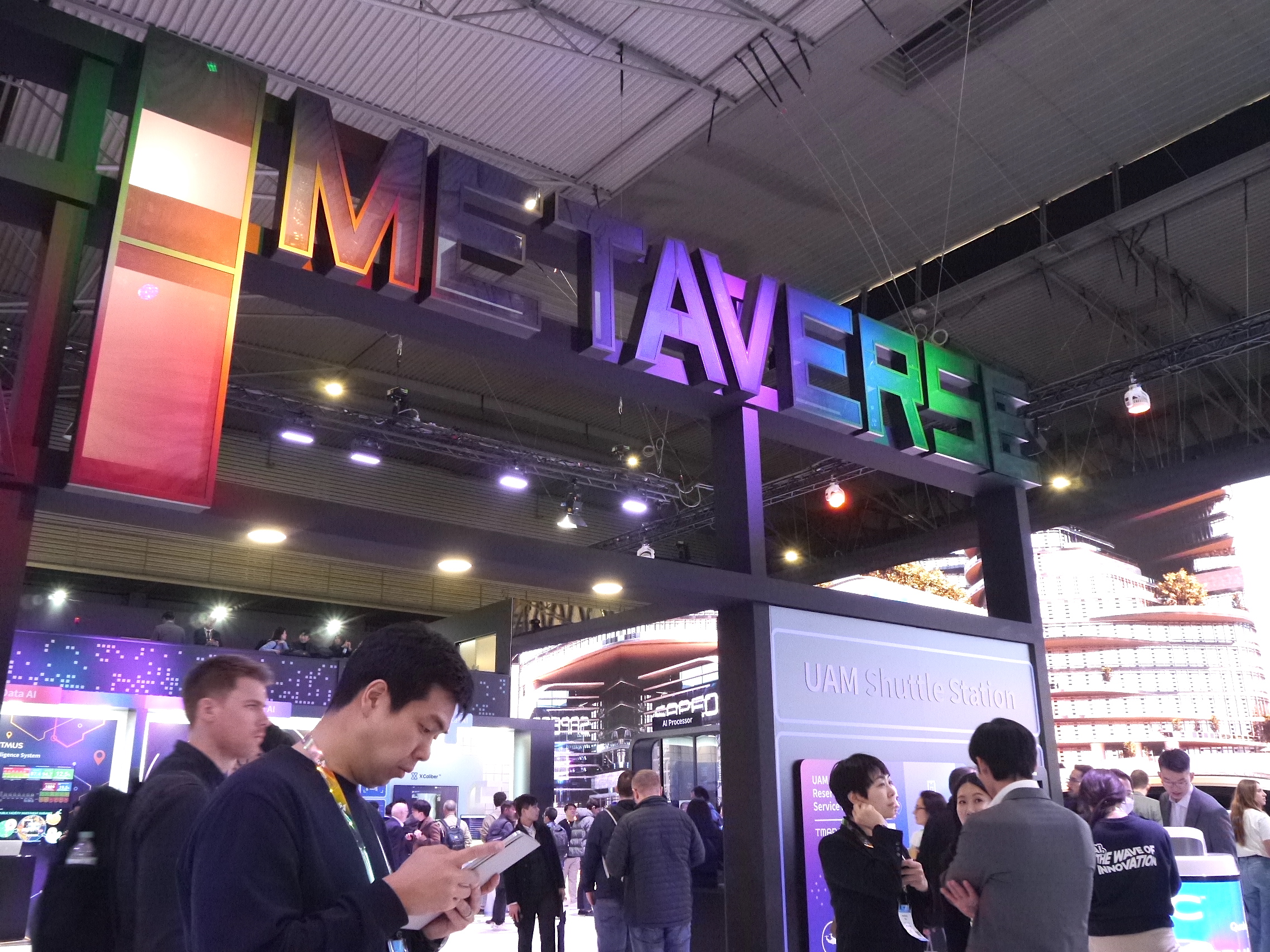A colorful 'Metaverse' logo is displayed above a stand at the MWC 2023 trade show in Barcelona