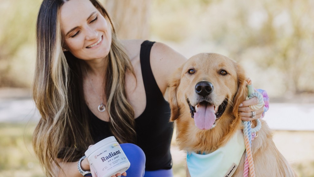 Woman sitting with dog and Bundle x Joy pet products
