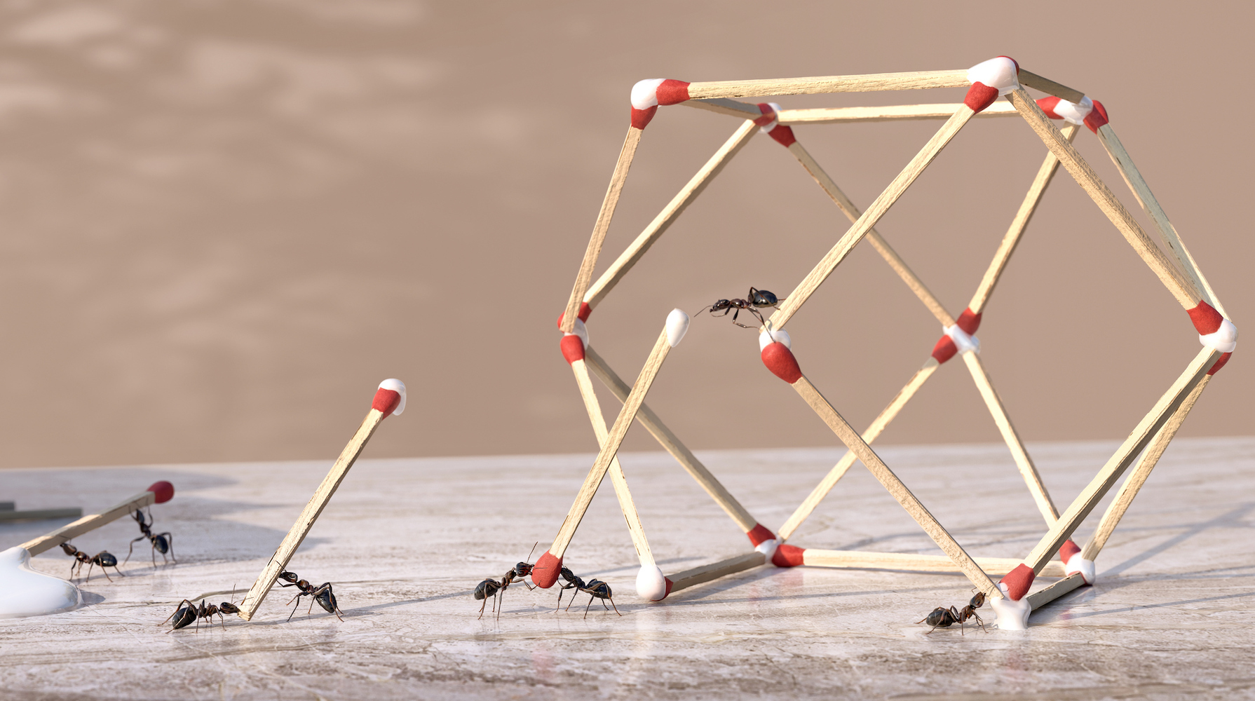 A group of ants working as a team to form a three dimensional geometric sculpture from glue and matchsticks. The ants are dip ends of matchsticks in glue dripping from a bottle of glue and place in position to form the shape on a marble worktop.