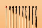 Image of matchsticks against a pale orange background.