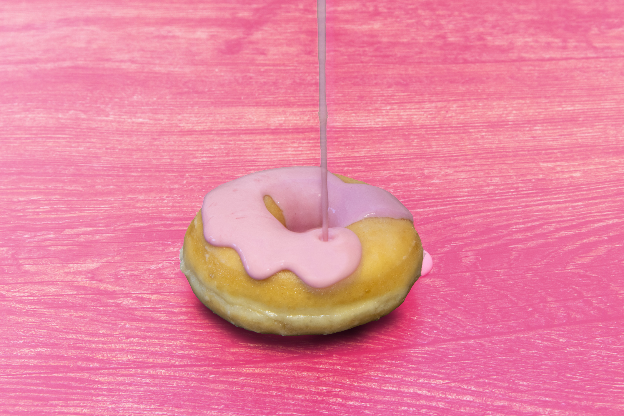 donut with pink filling on a pink table