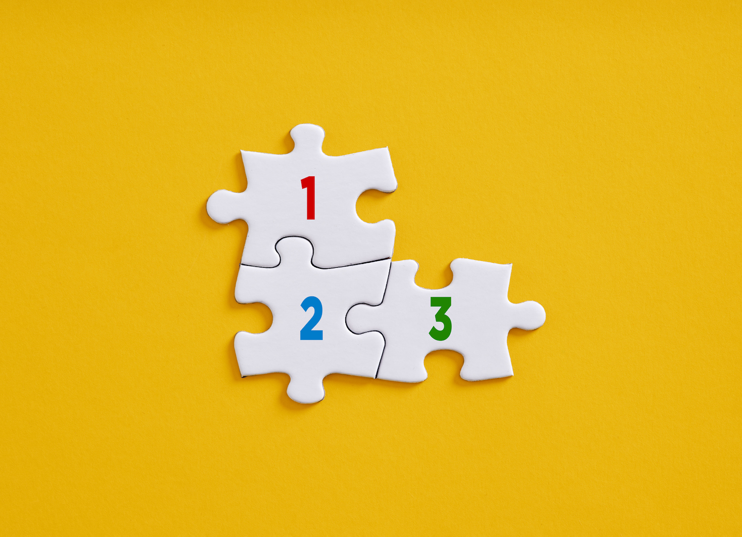 Numbers 1 2 3 on connected jigsaw puzzle pieces. 3 tips for crypto startups preparing for continued compliance