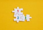 Numbers 1 2 3 on connected jigsaw puzzle pieces. 3 tips for crypto startups preparing for continued compliance