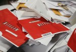 Netflix DVD envelopes sit in a bin of mail.