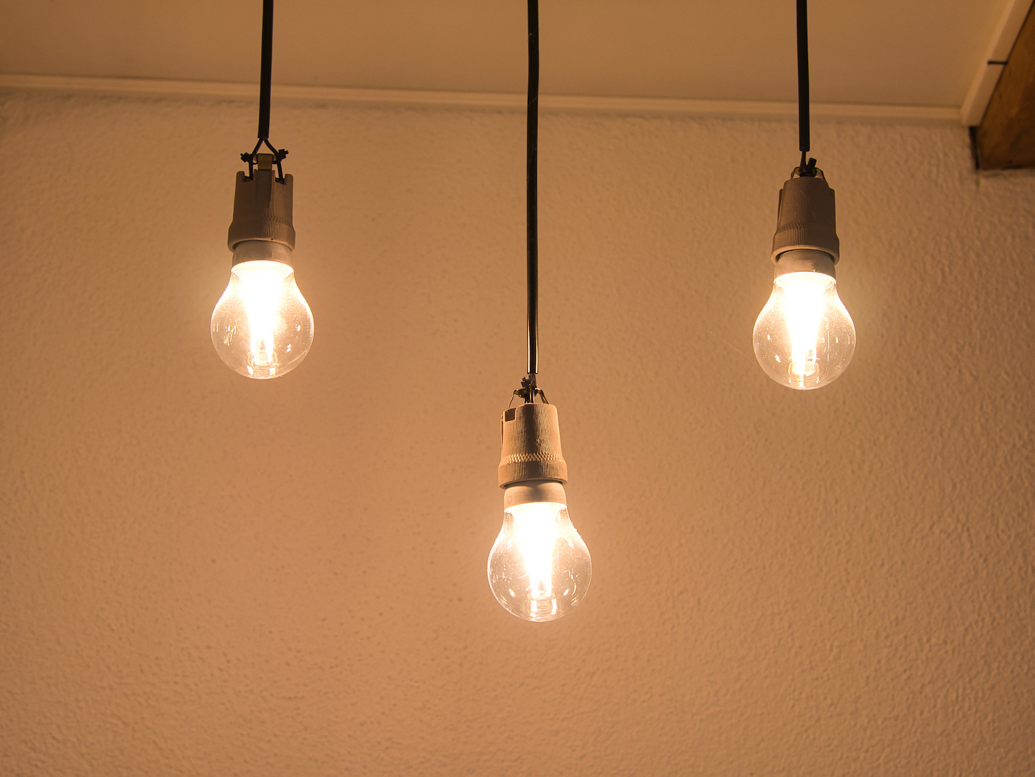 three light bulbs hanging from the ceiling