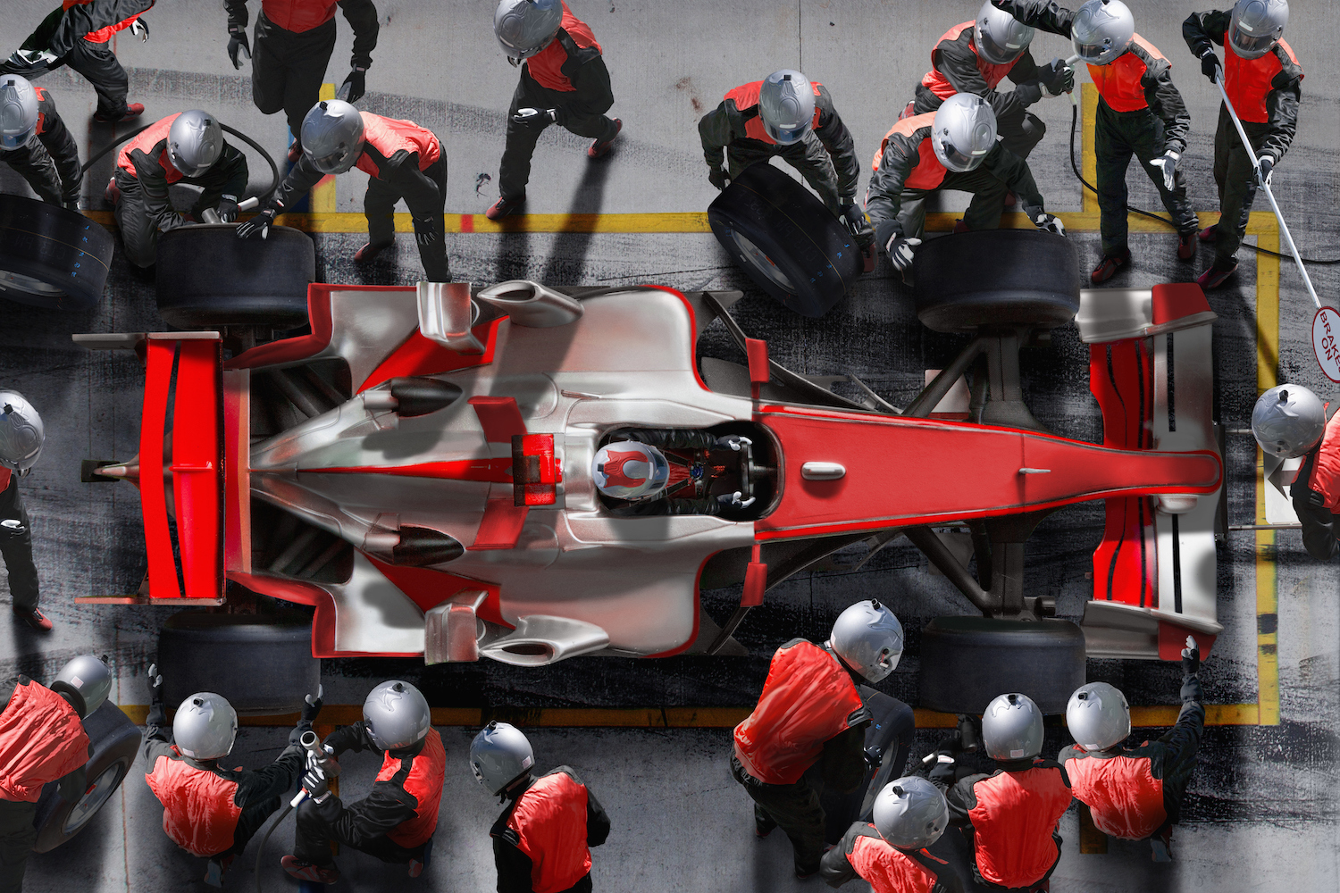 F1 pit crew work on an F1 car.