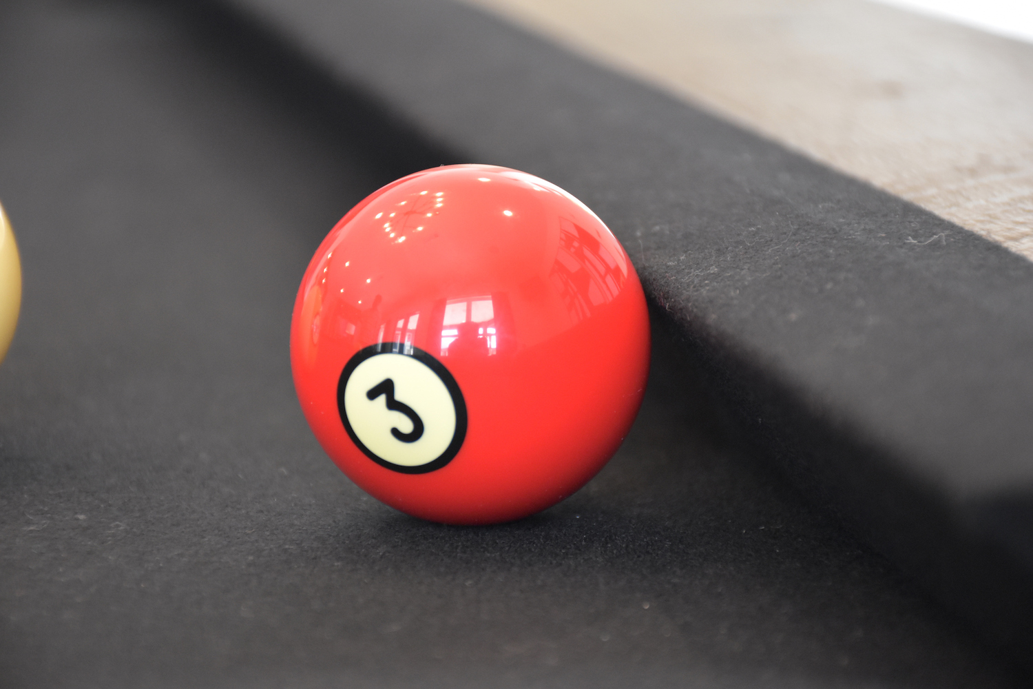 Black billiard table, Billiard balls in a pool table, focused on 3 ball