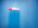 pink umbrella in a rain shower, conceptually photographed