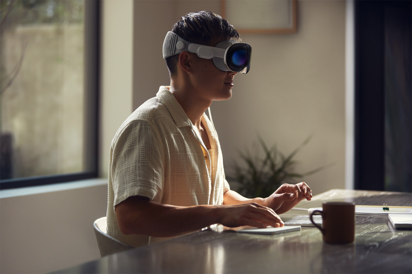 man sitting at desk with AR headset