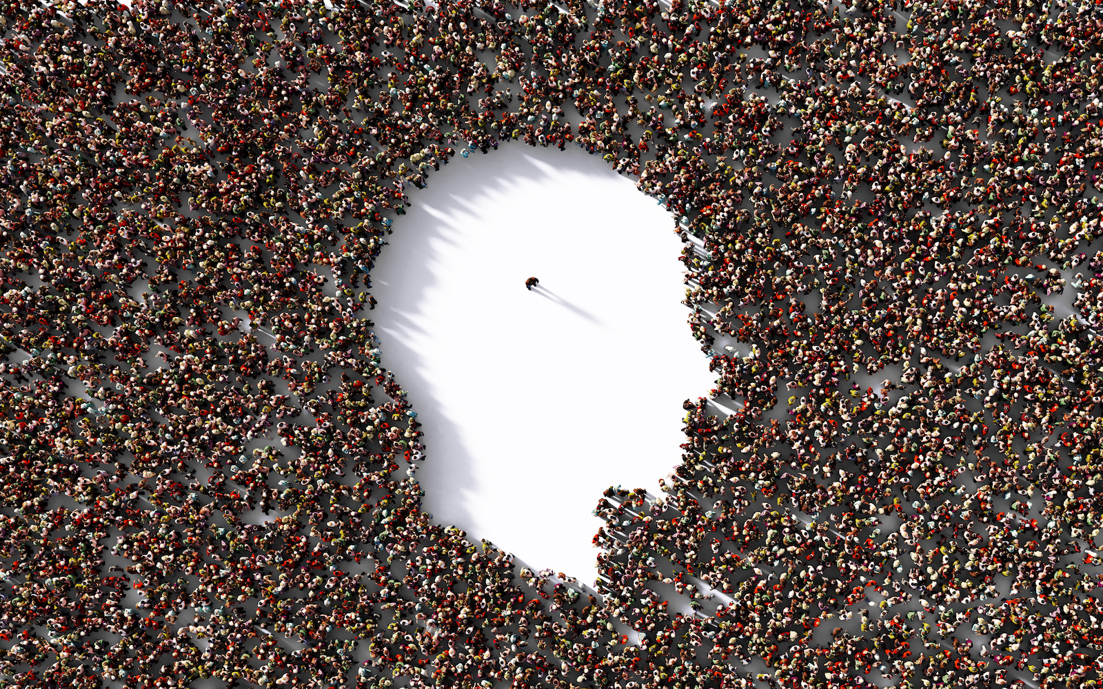 Single man standing inside of a human head shape which is formed by human crowd on white background. Horizontal composition with clipping path and copy space.