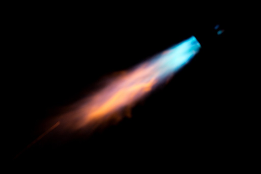 Gas flame over black sky background