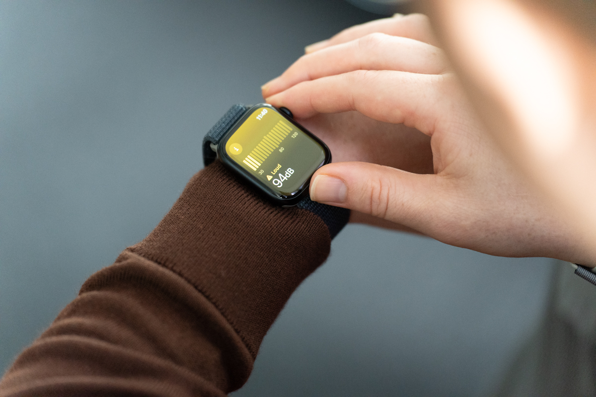 Apple Watch Series 9 on a wrist, showing the Noise app with a 94db reading