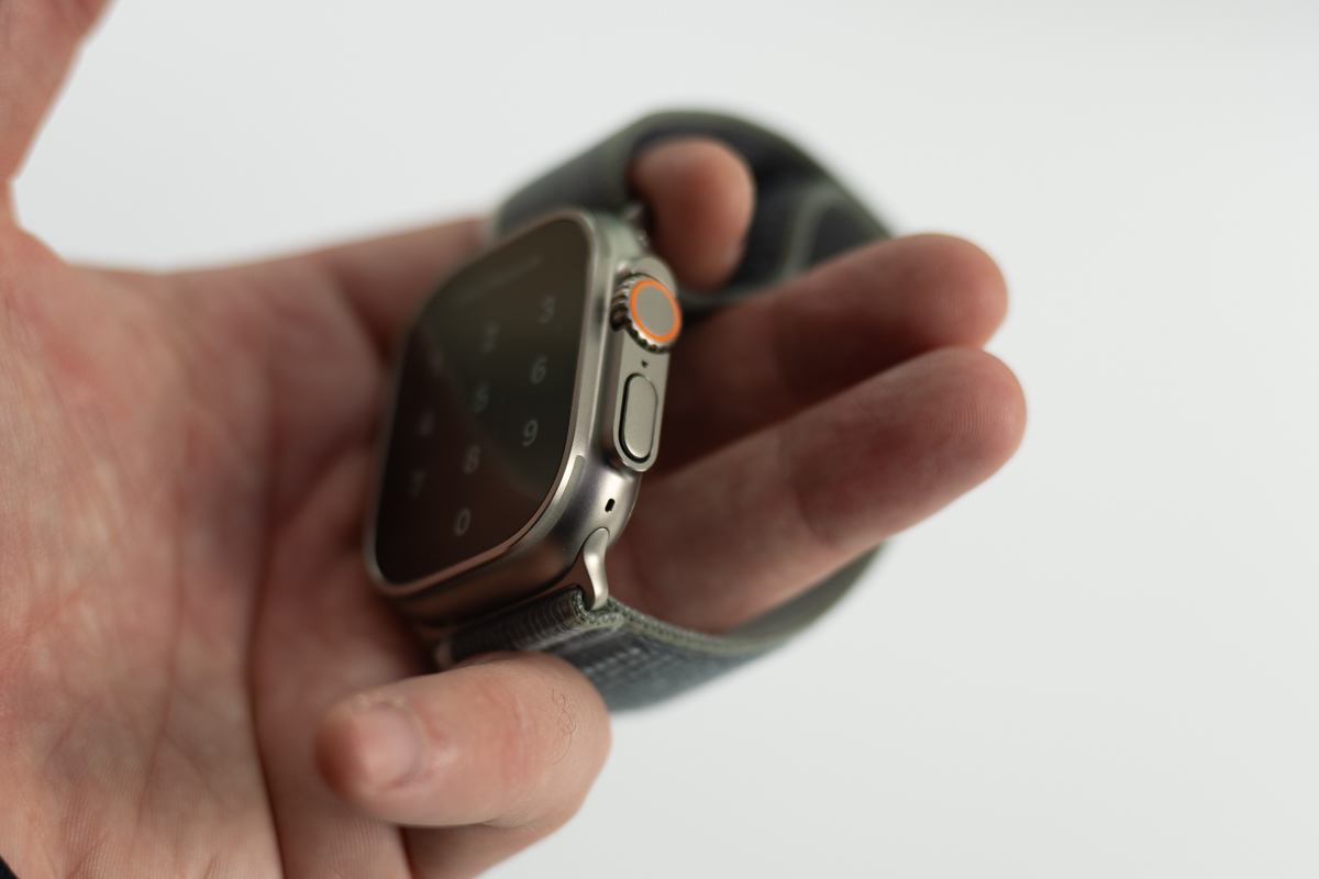 Apple Watch Ultra 2 held in a hand, showing the side button and Digital Crown