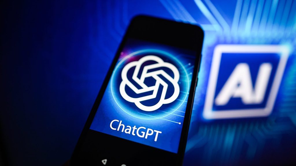 In this photo illustration a Chat GPT logo is seen displayed on a smartphone with Artificial Intelligence (AI) logo in the background.