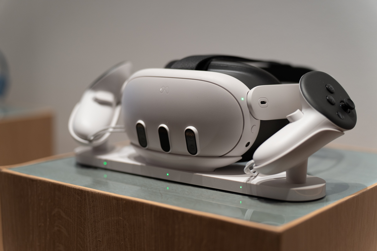 The Meta Quest 3 mixed reality headset, sitting on Meta's first-party charging stand