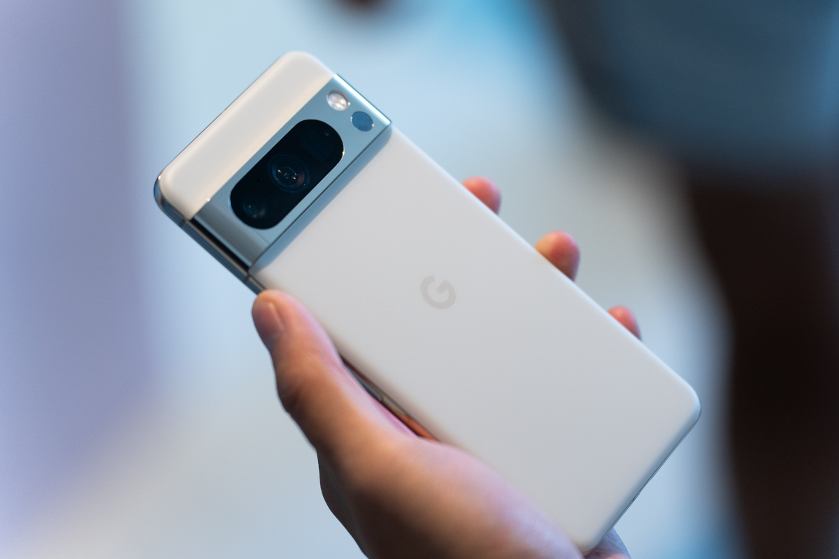 Google PIxel 8 Pro in white being held, showing the back