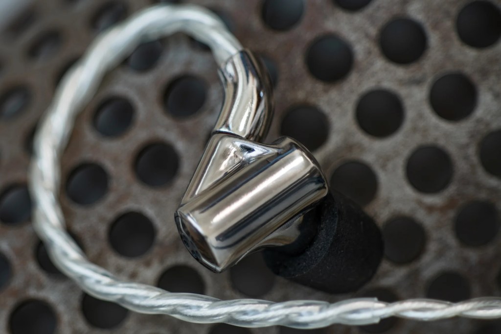 Singularity's ONI earbud, connected to its twisted audio cable