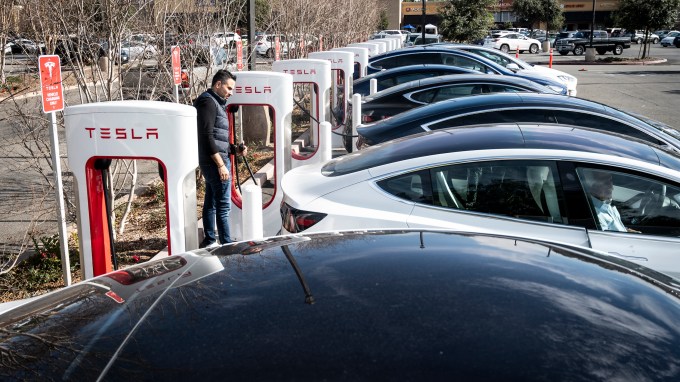 A Tesla supercharger station filled with electric cars.