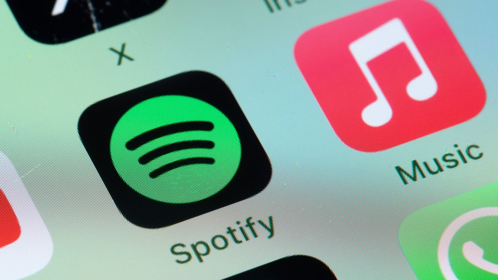 Spotify, Apple Music on smart phone screen.