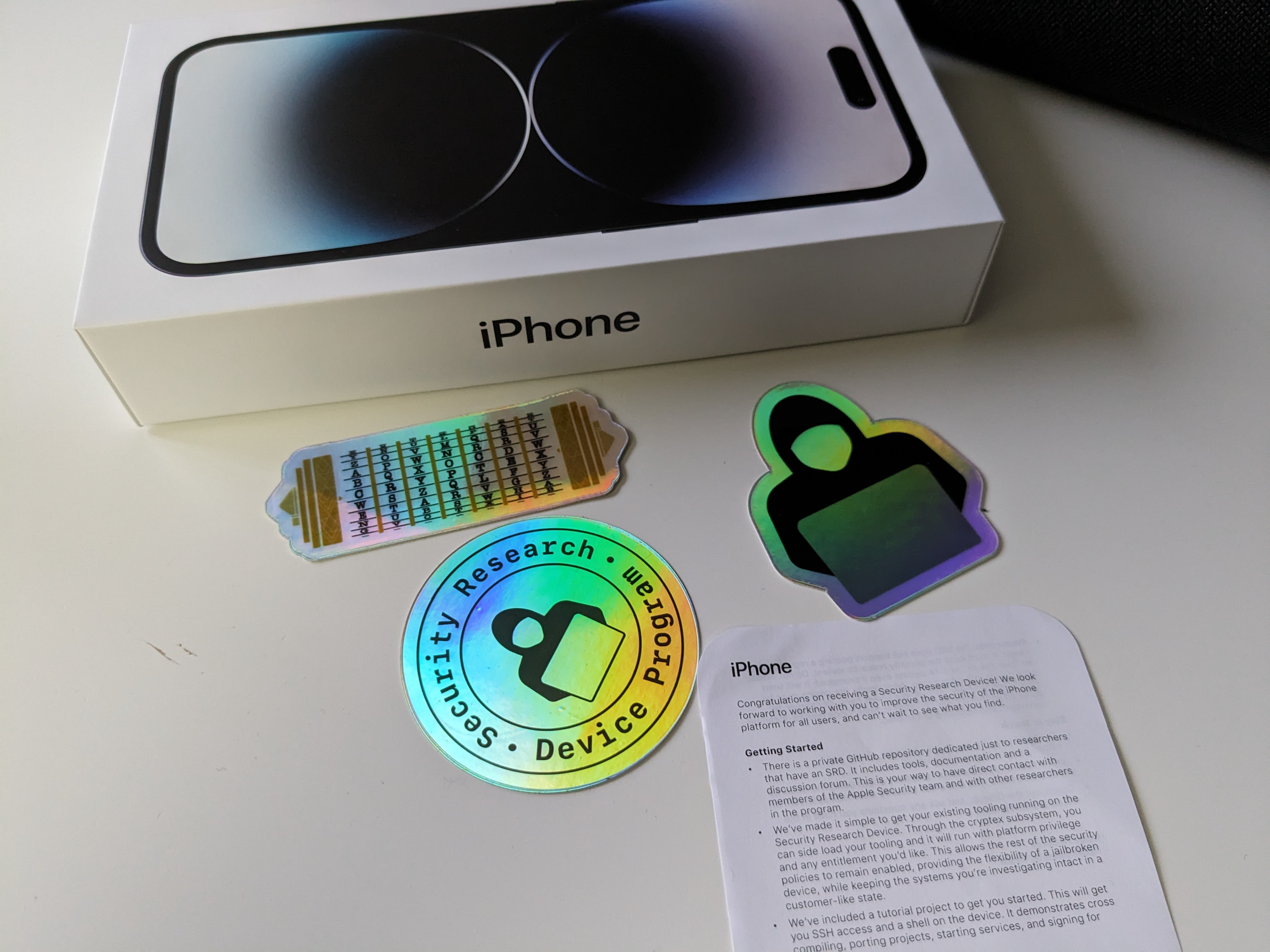 An iPhone Security Research Device with stickers and instructions.